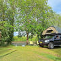A roof tent pitched under the trees
